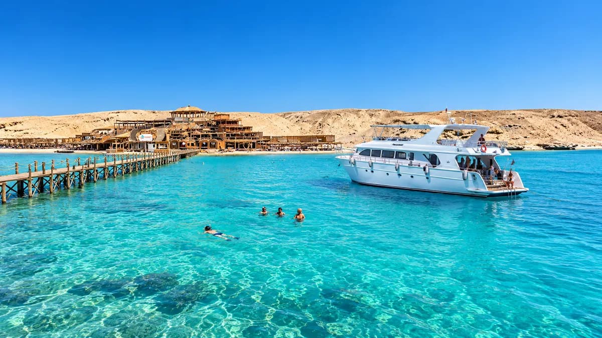 Boat anchored in clear turquoise Red Sea water